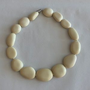 Dinosaur Design Crème Resin Necklace.